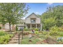 Charming two-story home with a welcoming front yard, lush landscaping and inviting staircase at 3157 Oakdale Rd, Hapeville, GA 30354