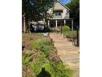 Charming two-story home with landscaped front yard and welcoming staircase leading to the front porch at 3157 Oakdale Rd, Hapeville, GA 30354