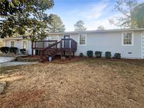 Charming single-story home featuring a wooden front porch and well-manicured front lawn at 730 Mount Zion Nw Rd, Conyers, GA 30012