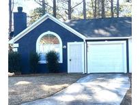 Charming home featuring a chimney, arched window, and a one-car garage at 3611 Spring Pt, Decatur, GA 30034