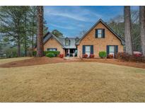 Charming brick home featuring manicured landscaping and a well-maintained front lawn at 3496 Honeycomb Dr, Conyers, GA 30094