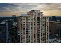 Stunning exterior shot of a tall condo building with a beautiful sunset backdrop at 3445 Stratford Ne Rd # 2403, Atlanta, GA 30326
