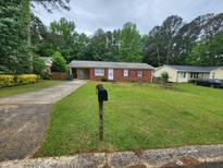 Cozy single-story home with a well-maintained lawn and a long driveway at 10836 Mallard Dr, Jonesboro, GA 30238