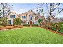 Charming two-story traditional home featuring manicured lawn and a welcoming front entrance at 400 Laurel Chase Ct, Atlanta, GA 30327