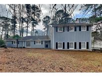 Charming two-story home featuring a cozy front yard and classic shutters at 2382 Smokehouse Path, Lawrenceville, GA 30044