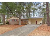 Traditional ranch style house with covered carport and a brick front exterior at 4648 Seward Rd, Powder Springs, GA 30127