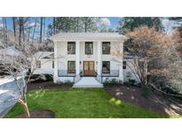 Stunning two-story home with a well-manicured lawn, white brick exterior, and stately columns at 2231 Fairoaks Rd, Decatur, GA 30033