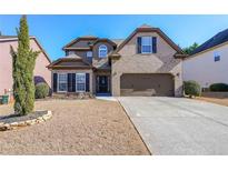 Charming two-story brick home with a well-manicured lawn and two car garage at 4972 Arbor View Nw Pkwy, Acworth, GA 30101