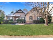 Charming home featuring manicured lawn, mature landscaping, and inviting front entrance at 772 Crescent Cir, Canton, GA 30115