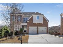 Charming two-story brick home featuring an attached two-car garage and manicured landscaping at 4669 Prater Se Way, Smyrna, GA 30080