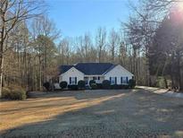 Charming single story home with black shutters, mature trees, and a well-maintained lawn in a desirable location at 922 Scarletts Walk, Locust Grove, GA 30248