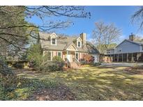 Charming home features a well-maintained lawn and mature trees providing a serene and private setting at 1765 Round Rd, Grayson, GA 30017