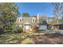 Charming two-story home with dormer windows, attached garage, and a well-maintained front yard at 1765 Round Rd, Grayson, GA 30017