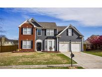 Charming two-story home featuring a two-car garage, brick accents, and a well-manicured lawn at 3028 Hallman Cir, Marietta, GA 30064