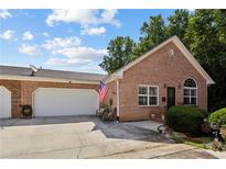 Charming single-story brick home with a spacious two-car garage and a well-manicured front lawn, creating an inviting curb appeal at 3321 Raes Creek Rd # 11, Marietta, GA 30008