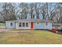 Charming one-story home featuring a red front door and light blue painted brick at 2212 Brannen Se Rd, Atlanta, GA 30316