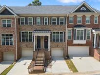 Charming brick townhome showcasing a well-maintained exterior and inviting curb appeal at 1552 Mosaic Way, Smyrna, GA 30080