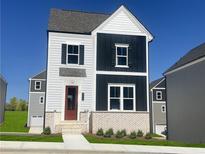 Charming two-story home featuring white and black siding, complementary shutters, and a red front door at 2709 Creek View Nw Ter, Atlanta, GA 30318