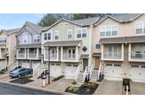 Charming townhomes featuring attached garages, quaint balconies, and welcoming staircases, all with colorful exterior finishes at 1152 Liberty Nw Pkwy, Atlanta, GA 30318