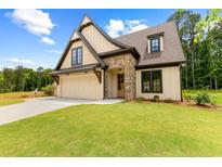 Beautiful craftsman home featuring a stone facade, manicured lawn, and a two-car garage at 210 Regester Way, Peachtree City, GA 30269