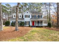 Charming two-story home with covered front porch and a neatly landscaped yard at 1463 Wood Park Nw Way, Kennesaw, GA 30152