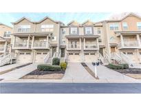 Charming townhome with a one car garage, quaint front porch, and beautifully landscaped front yard at 1501 Liberty Nw Pkwy # 2307, Atlanta, GA 30318
