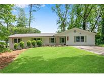 Charming one-story home featuring a lush lawn, freshly painted brick, and a welcoming front entrance at 4770 Wayland Cir, Acworth, GA 30101