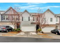 Charming townhome with gray siding, two-car garage, and well-maintained landscaping at 5528 Donerail St, Lithonia, GA 30058