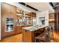 Modern kitchen boasts stainless steel appliances, custom cabinets, granite counters, and a large island at 500 Means Nw St # F, Atlanta, GA 30318