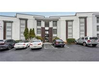 Exterior view of a condo building with parking lot and modern architectural style at 1445 Monroe Ne Dr # G7, Atlanta, GA 30324