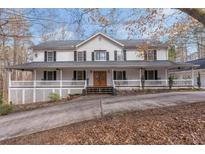 Charming two-story traditional home with inviting full length covered front porch and double door entrance at 1700 Bailey Creek Sw Rd, Conyers, GA 30094