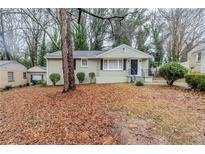 Charming one-story home with manicured lawn and mature trees providing shade and curb appeal at 1850 Brewer Sw Blvd, Atlanta, GA 30310