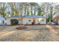 Charming one-story home with an orange front door, complemented by a well-maintained front yard at 2080 Dellwood Pl, Decatur, GA 30032