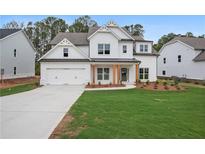 Stunning two-story home with a crisp white exterior, gabled roof, and inviting front porch at 2021 Shallowford Rd, Marietta, GA 30066