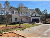 Two-story home boasts a manicured front yard, inviting entryway, and an attached two-car garage at 2021 Shallowford Rd, Marietta, GA 30066