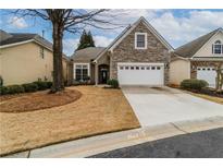 Charming home with stone accents, well-maintained yard, and a two-car garage offers curb appeal at 832 Chalet Hls, Mcdonough, GA 30253