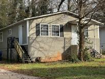 Charming single-story home featuring a brick foundation, complemented by a well-maintained yard at 1171 Wedgewood Nw Dr, Atlanta, GA 30318