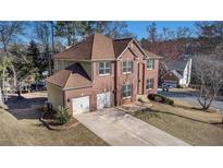 Beautiful two-story brick home with a three car garage and a well maintained front yard at 10950 Glenhurst Pass, Duluth, GA 30097