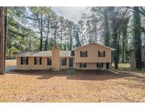 Traditional two-story home with brick chimney and mature trees at 3090 Chimney W Rdg, Snellville, GA 30078