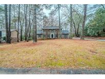 Charming two-story home with traditional design and mature trees in a landscaped yard at 1838 Nicole Ln, Lithonia, GA 30058