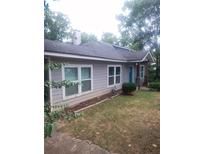 Charming one-story home featuring large windows, landscaped yard, and light-gray siding at 1268 Wylie Se St, Atlanta, GA 30317