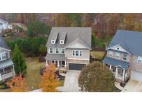 Beautiful two-story home featuring stone accents, neutral siding, an attached garage, and a well-maintained front yard at 322 Kells Ct, Woodstock, GA 30188