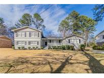 Charming gray home with black shutters and a manicured lawn in a residential neighborhood at 4124 Casa Loma Dr, Decatur, GA 30034