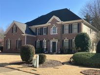 Traditional brick home showcasing detailed shutters and landscaping under clear blue skies at 2952 Nestle Creek Dr, Marietta, GA 30062