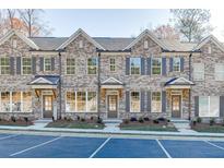 New brick townhomes featuring classic architectural details and individual entrances at 335 Collins Industrial Way, Lawrenceville, GA 30046