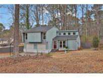 Charming two-story home with a two-car garage, inviting red door, and well-manicured front lawn at 670 Westbrook Pl, Lawrenceville, GA 30044