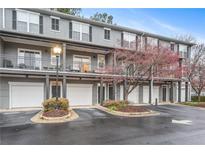 Charming condo building featuring a well-maintained facade, private balconies and convenient garage parking at 100 Brickworks Ne Cir # 104, Atlanta, GA 30307