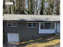 Charming single Gathering home featuring an attached garage and a well-maintained yard at 3188 Shallowford Ne Rd, Atlanta, GA 30341