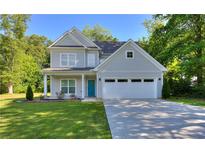 Charming two-story home with a well-manicured lawn, attached two-car garage and a welcoming blue front door at 419 Mcinnes Se Cir, Marietta, GA 30060
