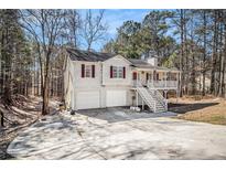 Charming two-story home with white siding, front porch, and a spacious two-car garage at 40 Joolio Dr, Rockmart, GA 30153